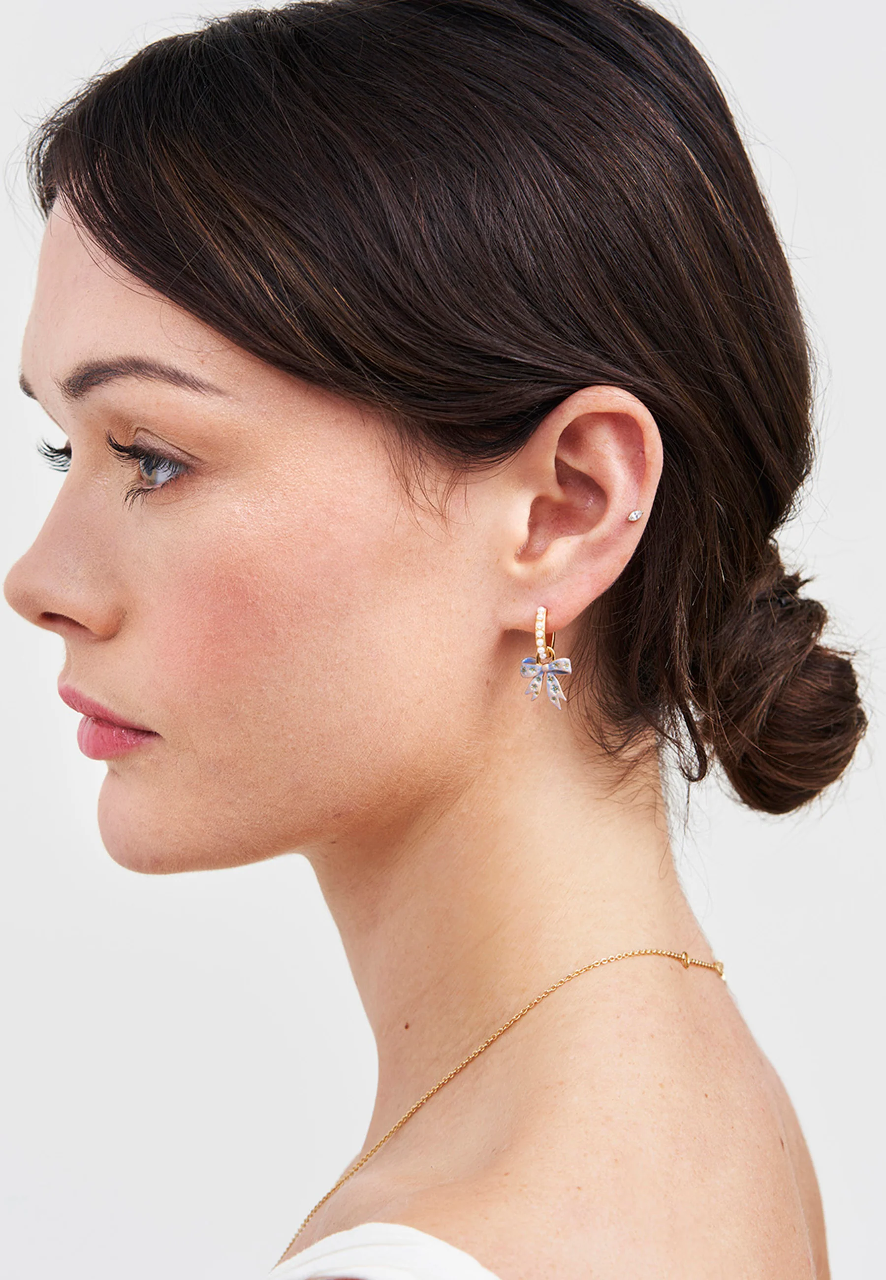 Gold Forget Me Not Bow Huggie Earrings - Image 6